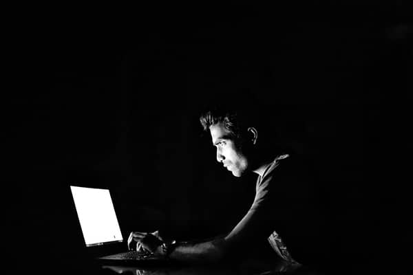 Man sitting in the dark with laptop