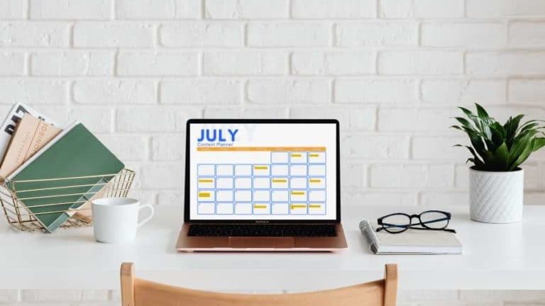 July content planner on laptop on desk
