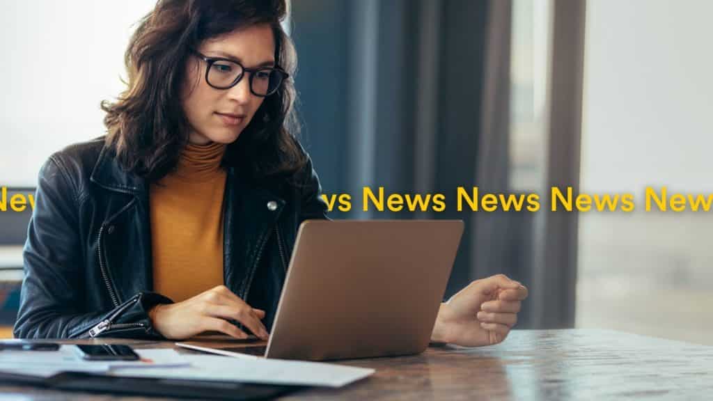 Woman reading news on laptop find out latest news July 2022 - Localsearch QLD